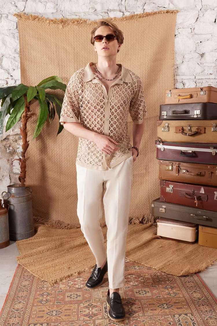 Artisanal handcrafted crochet garments — textured tops, shirts and pieces showing craftsmanship and slow fashion artistry