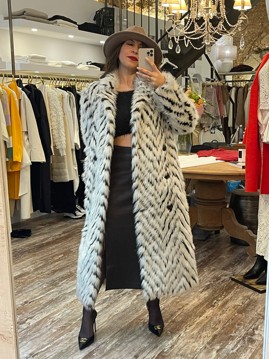 Ebru Gurlek at the shop, posing in front of a mirror.