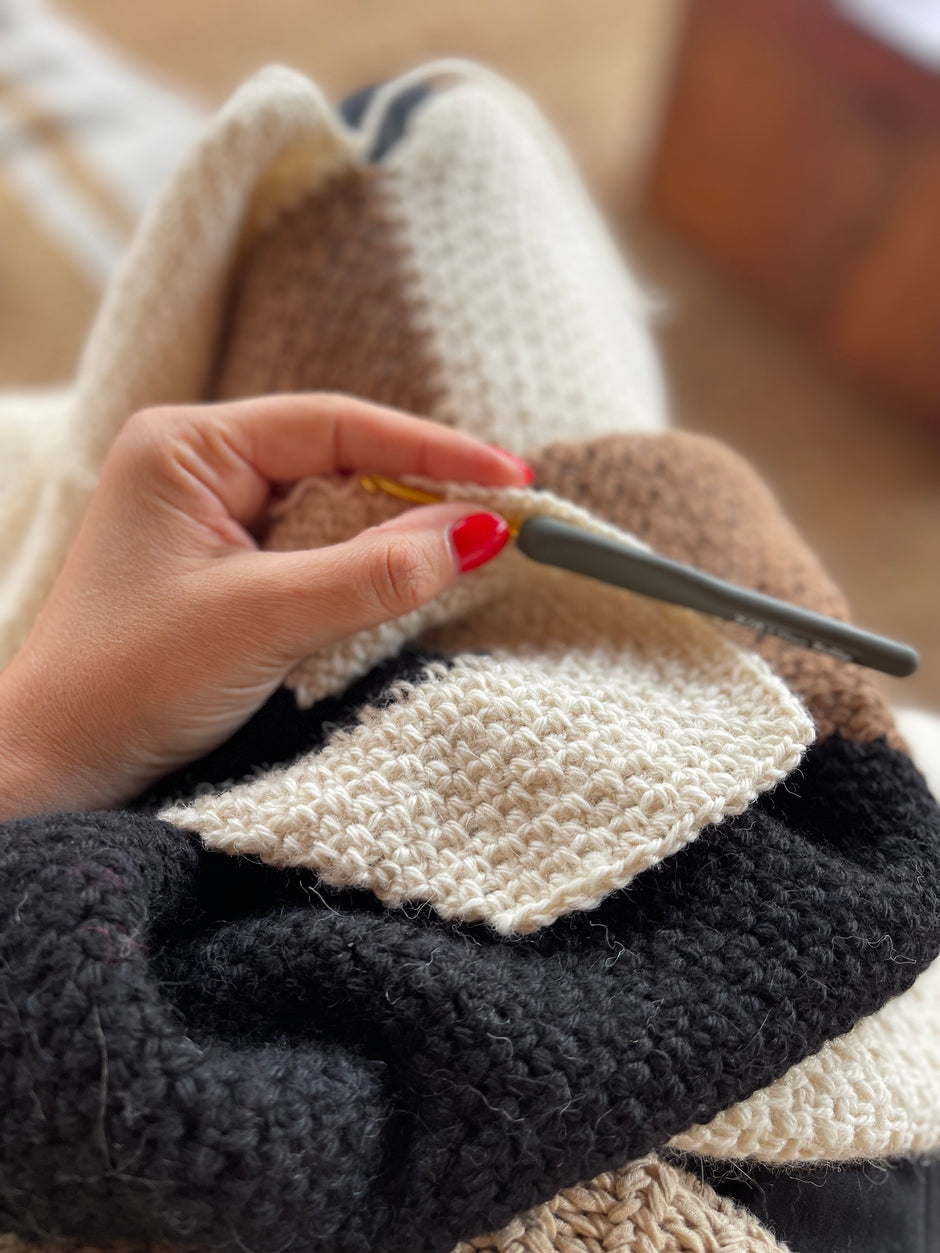 Ebru Gurlek crocheting a winter coat with alpaca yarn.